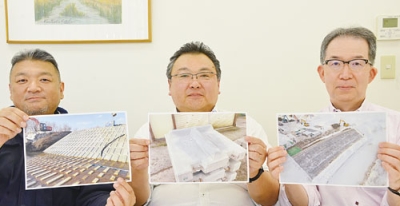 写真：スピリッツを使用したモデル工事現場の写真を持つ日鉄セメントの社員