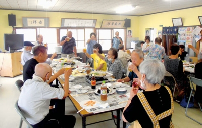 写真：食事や会話で交流を深める参加者たち（提供写真）