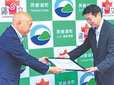写真：感謝状を受け取る田中事務長（右）