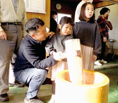 写真：大きいきねで餅をつく子ども