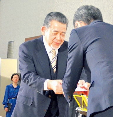 写真：室蘭市の奈良副市長に益金を手渡す坂下組合長