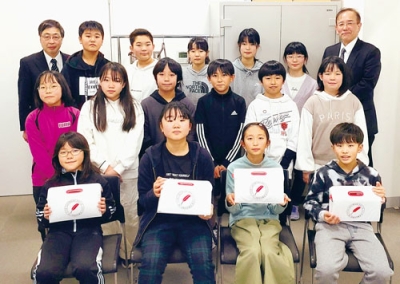 写真：赤い羽根共同募金へ学校募金を寄付した天神小児童会役員。後列左は髙木事務局長、同右は平石校長