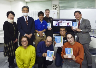 写真：本の出版記念の集まりで写真に納まる執筆者ら。前列右は鈴木みずめさん、後列右端が丹羽大輔さん＝２０２３年１１月、横浜市
