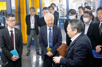 写真：藤井社長（右）からキメラの加工技術について説明を受ける及川氏（左）