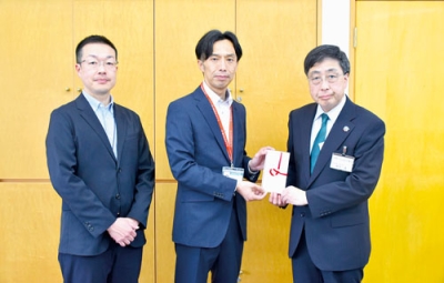 写真：（右から）髙木事務局長に目録を手渡す石川グループリーダーと四宮副長