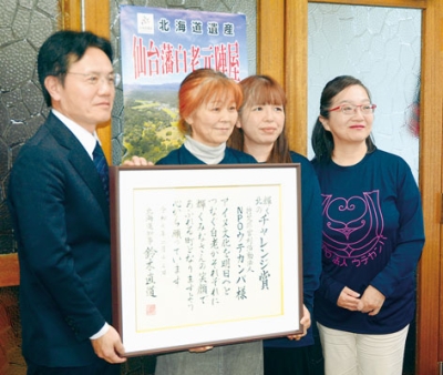 写真：大塩町長（左）に受賞を報告した田村代表（左から２人目）ら