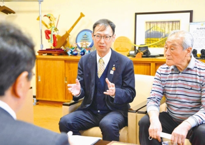 写真：小笠原市長へ意気込みを語る小川会長。右は中原前会長