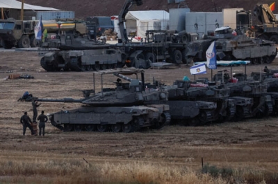 写真：１６日、パレスチナ自治区ガザ境界近くのイスラエル側で展開しているイスラエル軍の車両（ロイター＝共同）