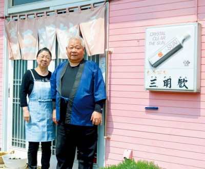 写真：「お食事処　三明歓」店主の山﨑英明さん（右）とひろ子さん