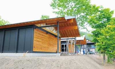 写真：仲とうや醸造所が建設しているワインの醸造所。奥はカフェ翡翠