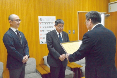 写真：安宅教育長から感謝状を受け取る安江会長（中央）