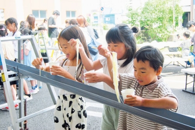 写真：流しそうめんを楽しむ子どもたち