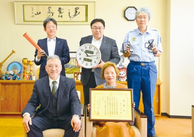 写真：トランシーバーなどを寄贈した羽山トヨ子さん（前列右）。隣は裕さん