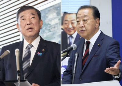 写真：国会で内閣不信任決議案を提出しないと正式表明する立憲民主党の野田代表。左は首相官邸で取材に応じる石破首相。今国会の衆院解散を見送る方針を固めた＝１９日午後