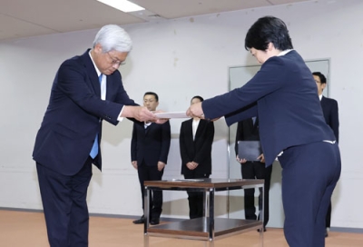 写真：国交省関東運輸局で処分の通知書を受け取る日本郵便の千田哲也社長（左）＝２５日午後、横浜市