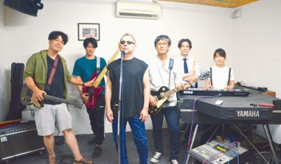 写真：「イベントを盛り上げたい」と話す金成さん（中央）とバンドのメンバー