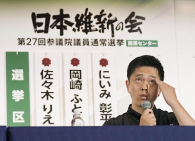 写真：記者会見で額に手をやる日本維新の会の吉村代表＝２０日午後９時２０分、大阪市内のホテル