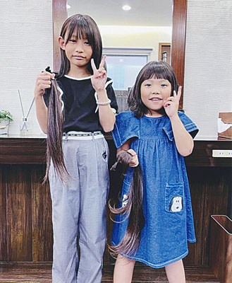 写真：ヘアドネーションに協力した花穂さん（左）と莉穂ちゃん