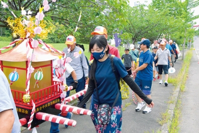 写真：みこしと一緒に町内を練り歩く参加者