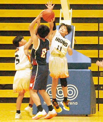 写真：相手へのジャンプシュートを厳しいチェックで阻止する室蘭アイアンズの選手たち