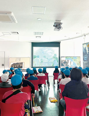 写真：映像で過去の有珠山噴火を学ぶ人たち