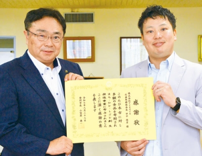 写真：小笠原市長（左）から感謝状を受け取る折田さん