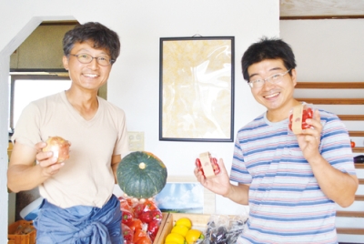 写真：新鮮な野菜を手に持つ舘山さん（右）と小林さん（左）