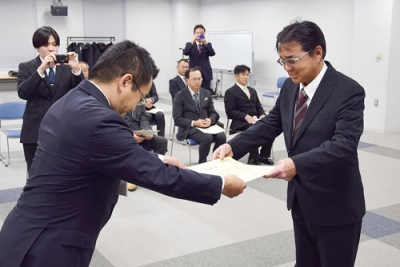 写真:功績をたたえられ感謝状を受け取る技術者