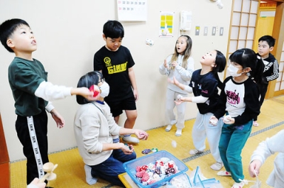 写真：休み時間に交流を深める「すみっこぐらし」のメンバーと児童