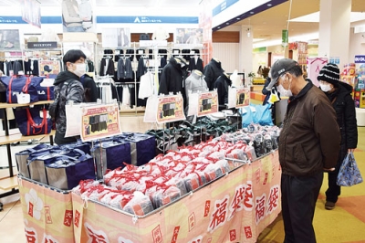 写真：お目当ての福袋を選ぶ買い物客＝２日、モルエ中島