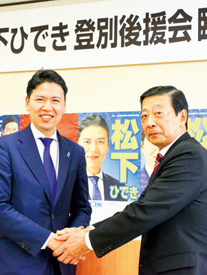 写真：中牧後援会長（右）と握手を交わす松下氏
