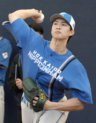 写真：ブルペンで投げ込む日本ハム・達＝名護