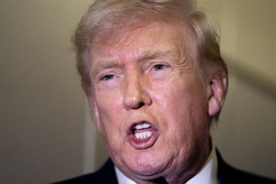 写真:ワシントンに向かう機内で記者団と話すトランプ米大統領=16日(ゲッティ=共同)