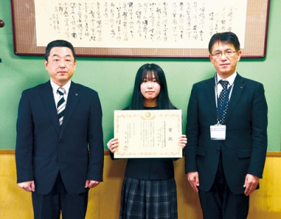 写真:「ことば・メッセージ部門の中学生の部」で最優秀賞に選ばれた中田さん(中央)