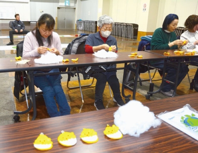 写真：手縫いでマスコットを作る女性部員